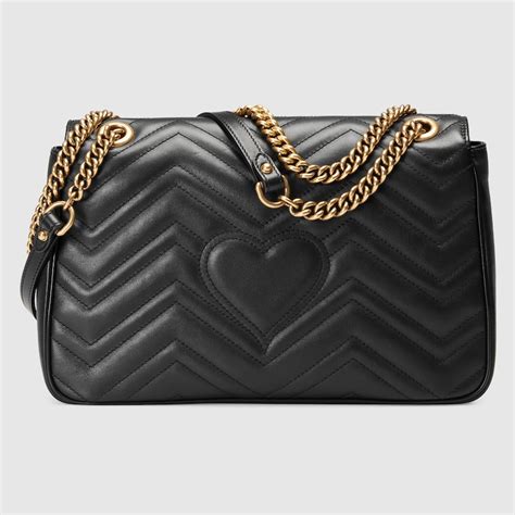 black gucci bag with two red hearts